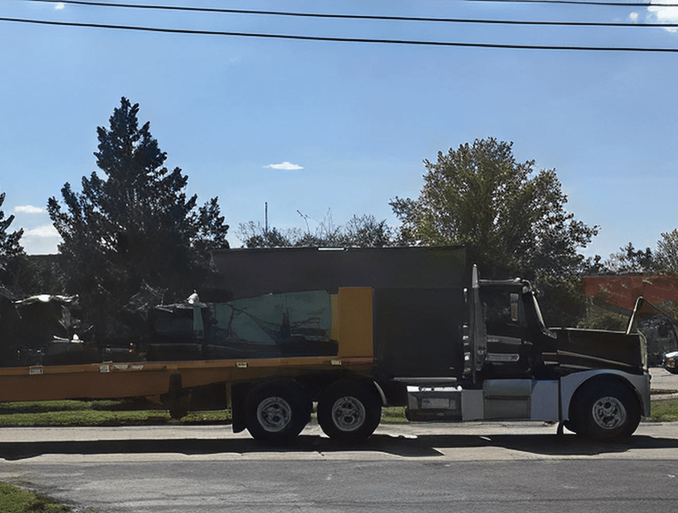 Industrial vehicle transporting machinery on road