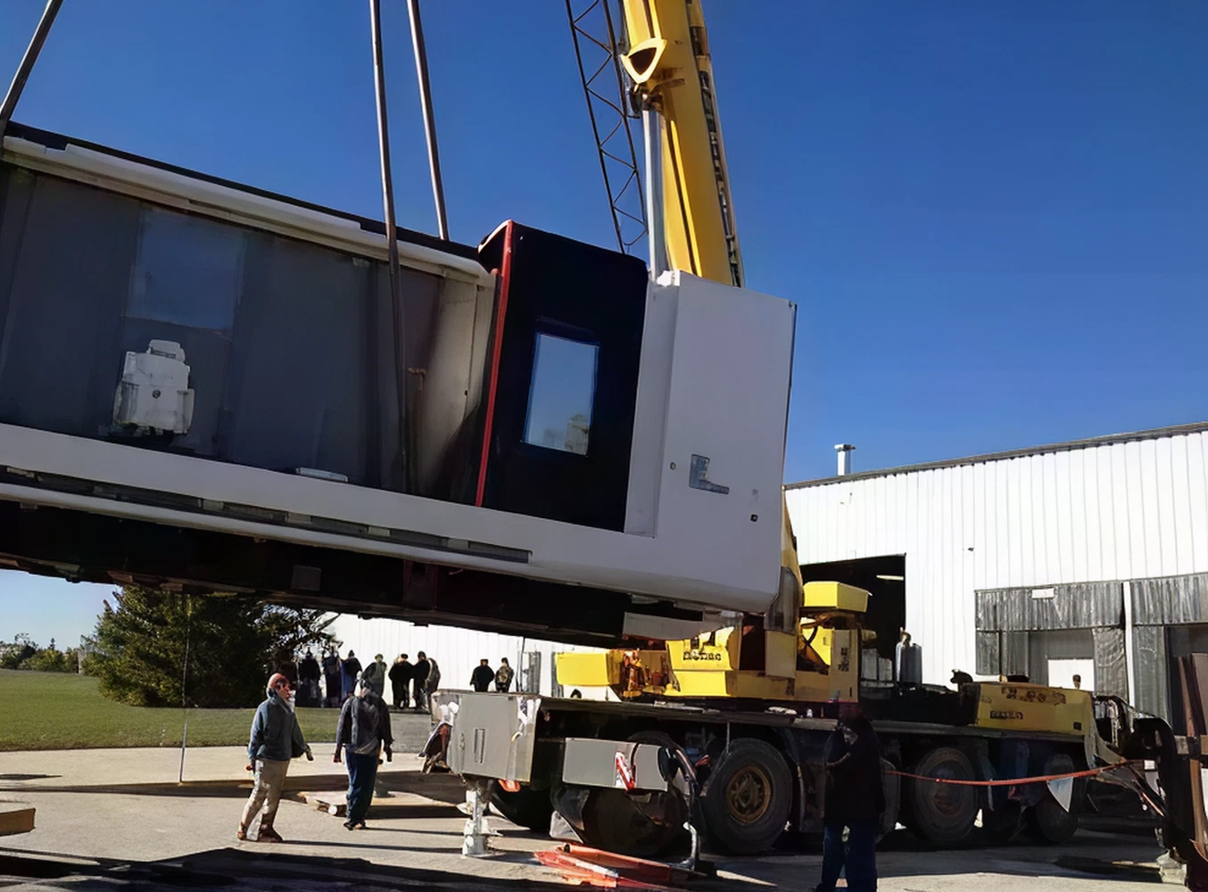 Crane lifting large industrial machine